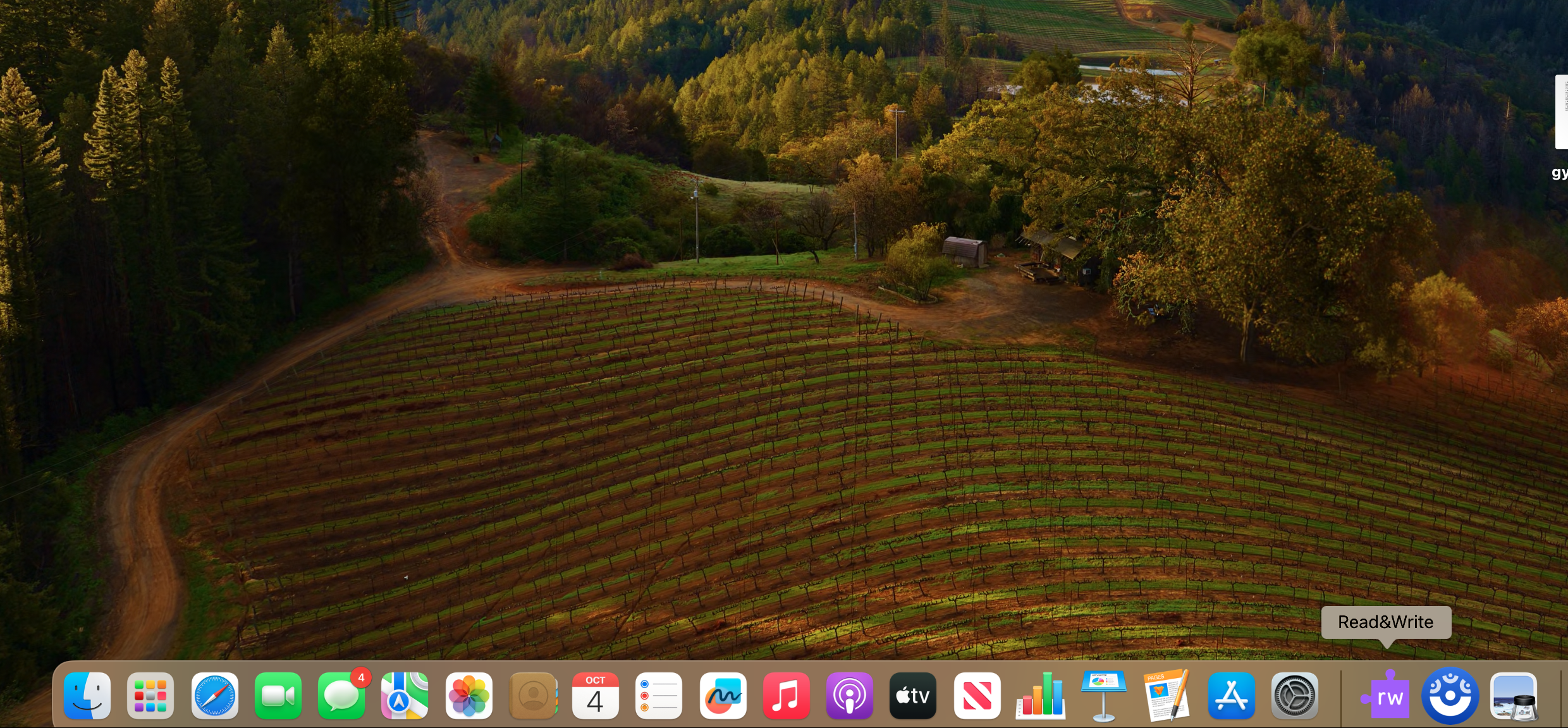 A screen shot of Mac home page with the Read&Write app on the bar at the bottom in the right-hand side.
